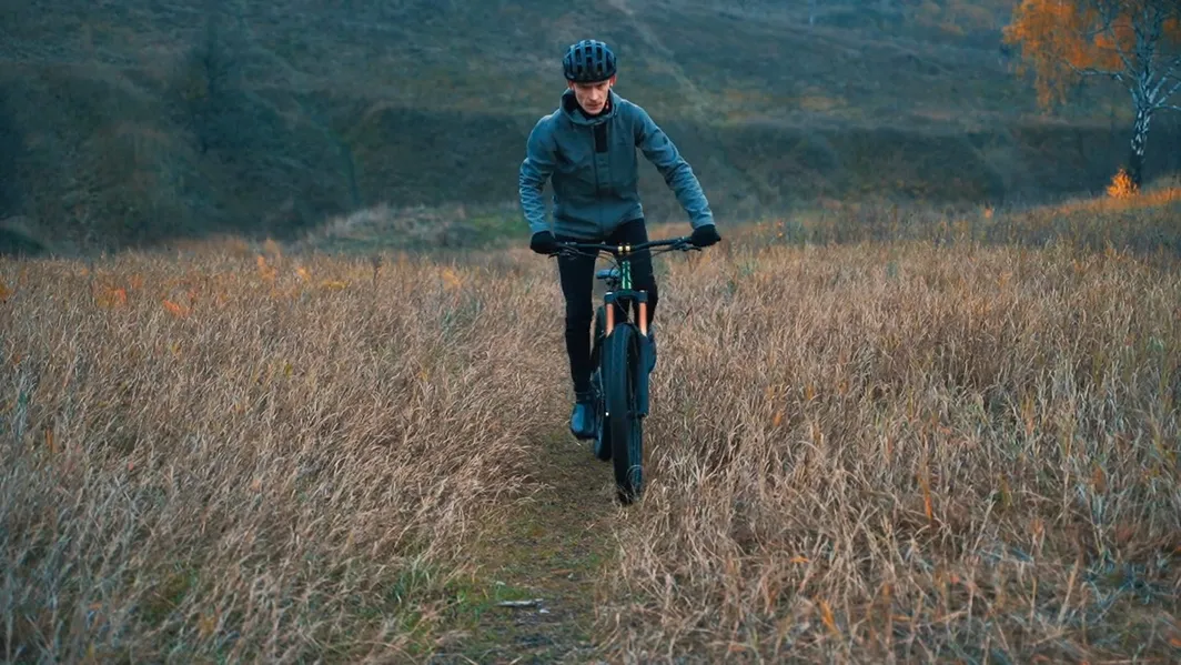 Person mountain biking on a trail