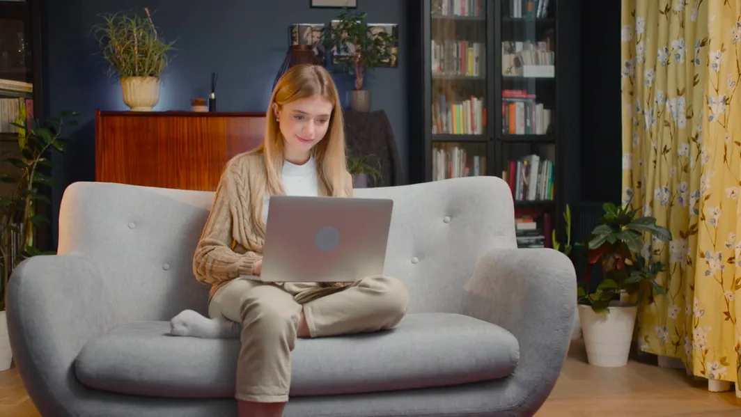 Person on a couch with a laptop